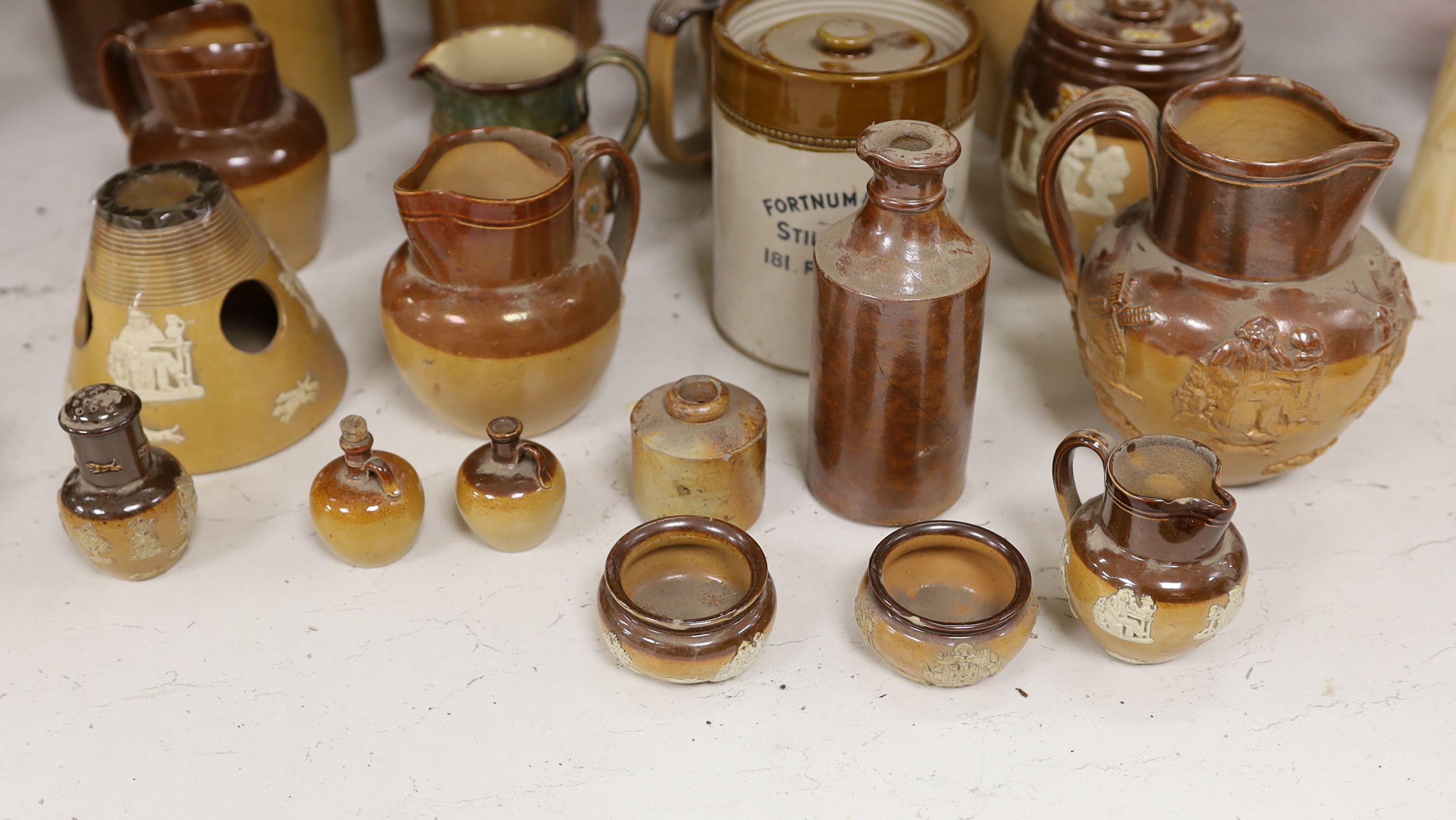 A quantity of Doulton stonewares including inkstand, jug, miniature salts and 19th century saltglaze pottery bottles, tallest item large jug 18 cms high.